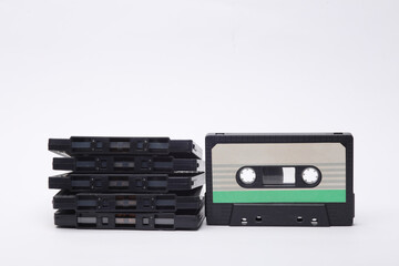 Stack of retro 80s audio cassettes on white background