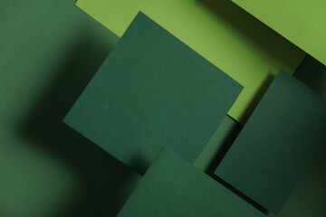 Set of green floating blank card sheets with shadow on green background. Minimalism business brand...