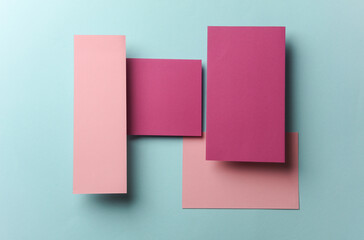 Set of pink floating blank card sheets with shadow on blue background. Minimalism business brand...