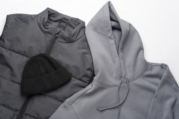 Men's sleeveless down jacket, hoodie with a hat on a white background. Flat lay