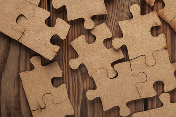 Wooden pieces jigsaw puzzle on wooden table