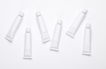 Set of white empty tubes of acrylic or oil paint for creativity on white background. Template for...