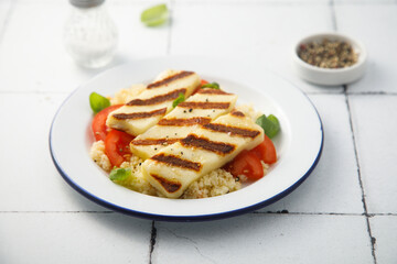 Grilled halloumi cheese with couscous and vegetables