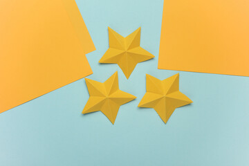 Yellow origami stars on a blue background