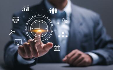 Time management concept. Businessman touching clock icon on virtual to work planning for increases efficiency and reduces work time. Business project planning.