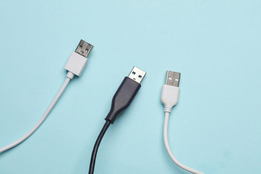 Three USB cables on a blue background