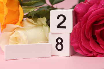 White Wooden calendar mockup with date 28 without month on pink background with flowers