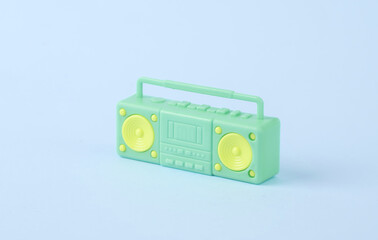 Plastic miniature boombox audio player on blue background