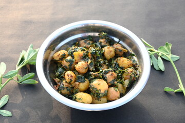 Aloo Methi or Fenugreek potato vegetable. It is made with fresh fenugreek leaves and potatoes. Indian homemade traditional Aalu Methi dry curry. Fenugreek potato sabzi  is healthy Indian Cuisine.
