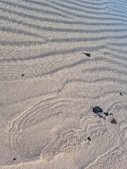 It is a textured sandy beach.