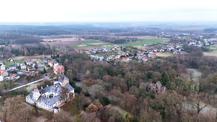 Zamek w Dąbrowie z wysokości 120 m z drona, budynki mieszkalne pola i las. © Stanisław Błachowicz