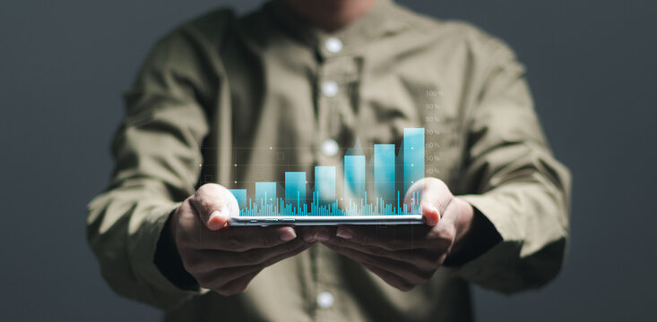 Businessman analyzes financial growth graph for long-term investment, Financial goals and global economic business planning.