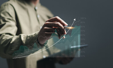 Businessman use pen drawing up arrow for analyzes financial growth graph for long-term investment,...