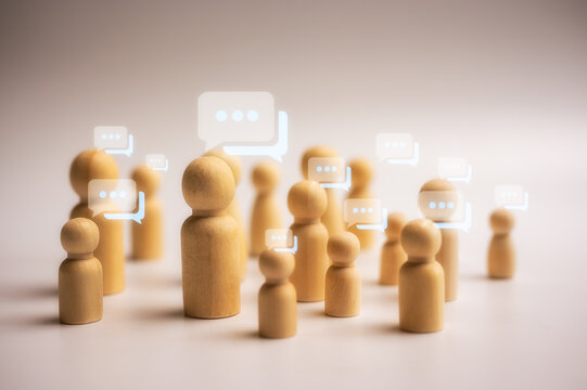 lifestyle and social media concept Social gathering with text message bubbles and icons on wooden dolls - Powered by Adobe
