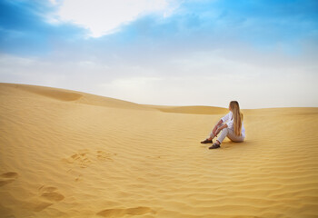 Beauty blond woman in desert. Sahara desert