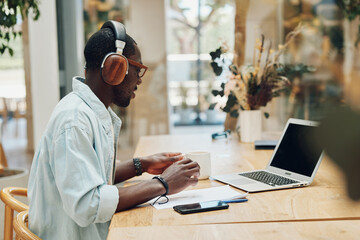 Man music business computer laptop person earphones online young listen working