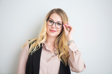 Young blond smiling woman in glasses