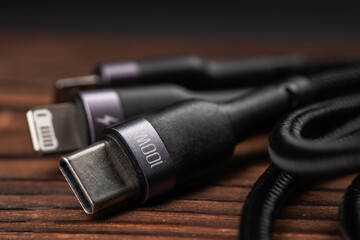 digital computer or smartphone cables. Usb type c, mini-usb, lightning connector. on wooden background