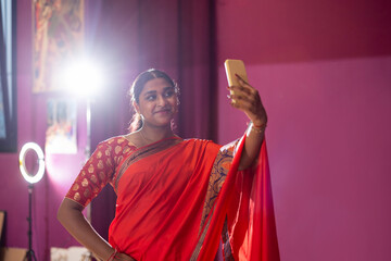 Indian influencer records herself live with her smartphone after Bollywood dance classes. Young Indian woman selfie