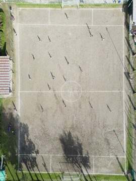 football field with players photographed from above with a drone