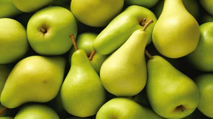 Foto op Plexiglas  a pile of green pears and pears with one pear cut in half and one pear in the middle. © Anna