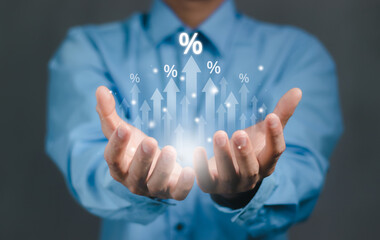 Businessman hand with rising arrow and percentage icon. Interest rate and dividend concept, Business finance and money concept, Investment growth, Return on stocks and mutual funds, profitability,.