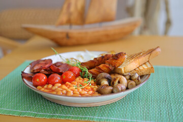 English breakfast - toast, egg, bacon and vegetables
