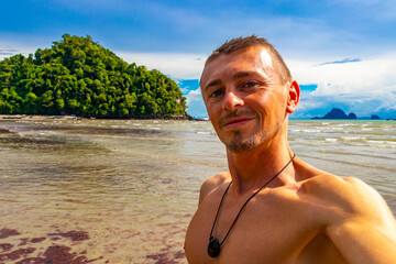 Man takes selfe photo tropical paradise beach Ao Nang Krabi Thailand.