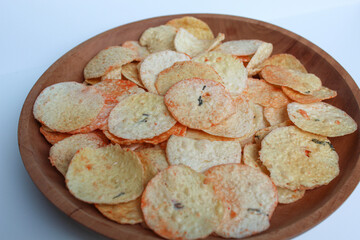 Opak is crisp made from cassava, shaped into a flat round shape. Snack from Indonesia. On a wooden...