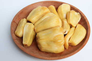 Yellow Jackfruit flesh from Artocarpus heterophyllus, on wooden plate, isolated on white background