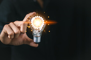 A businessman holding a light bulb,concept of creative thinking and innovation. inspiration and imagination in finding solutions. power of bright ideas and the energy bring to business and technology
