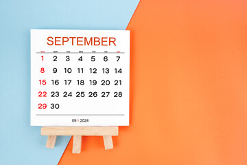 2024 September calendar page on blue and orange background.