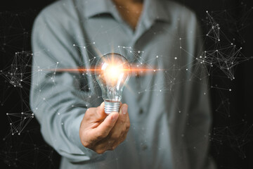 Smart business ideas, Businessman protects a glowing light bulb, symbolizing innovation and creativity. Illustrates the concept of brainstorming, solution, and successful profit in global business..