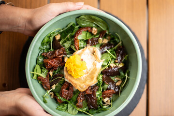 View from above of hands picking up a fig salad.