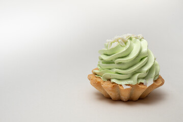 cupcake with icing and sprinkles, cake with cream on white background