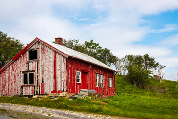 Fototapeta na wymiar Derelict traditional Norwegian red cabin on the island of Aukra