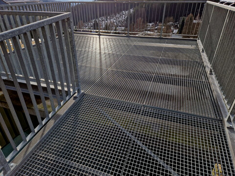 industrial hall, warehouse has a steep staircase with high resistance even under heavy load galvanized steel floor grate and railings. expanded metal, edges of stairs of safety, black, perforated