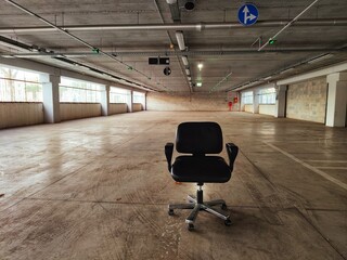 abandoned swivel chair in empty covered parking