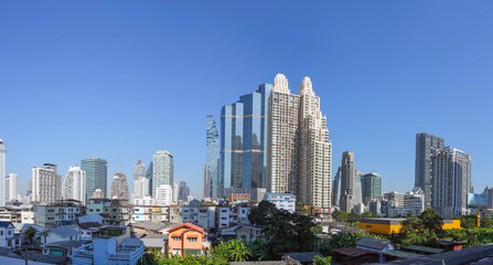 Fototapeta na wymiar Panoramic city skyline of Bangkok with slums on the foreground. Contrasts of a rapidly developing city and country economy