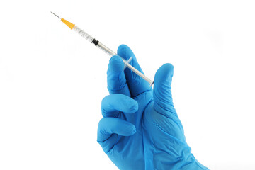 Vaccination syringe and hand in blue surgical glove