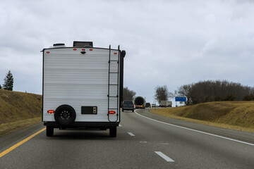 Caravan trailer on freeway road, family vacation is being taken, holiday trip is being taken in an...