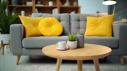 wooden coffee table and yellow chair in front of grey couch with pillows in trendy living room