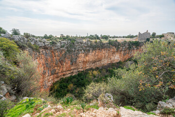 Fototapeta premium Amazing views from Kanlıdivane (ancient Canytelis), which is an ancient city situated around a big sinkhole in Mersin, Turkey.