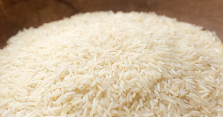 raw rice in wooden cup, close up