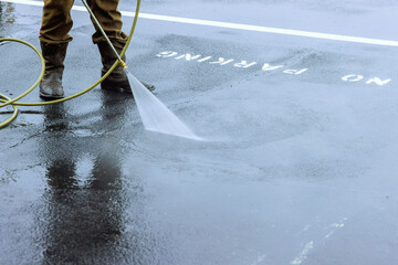 Street is sprayed with pressurized water to be cleaned, road is washed by water