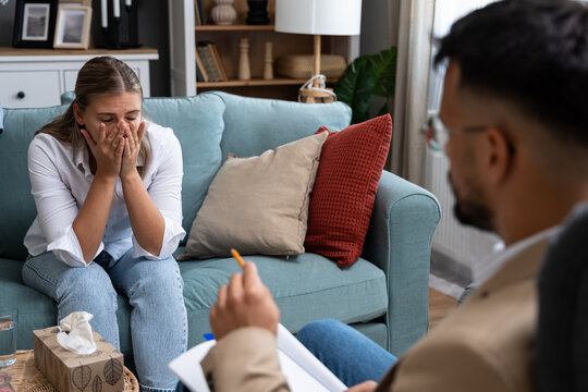 Young businesswoman undergoing psychotherapy after loss of her job bankruptcy of private company or the death of a close family member. Woman seeks help and solution from psychotherapist after divorce