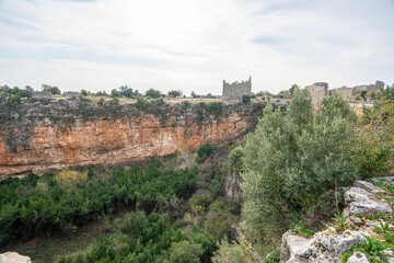Fototapeta premium Amazing views from Kanlıdivane (ancient Canytelis), which is an ancient city situated around a big sinkhole in Mersin, Turkey.