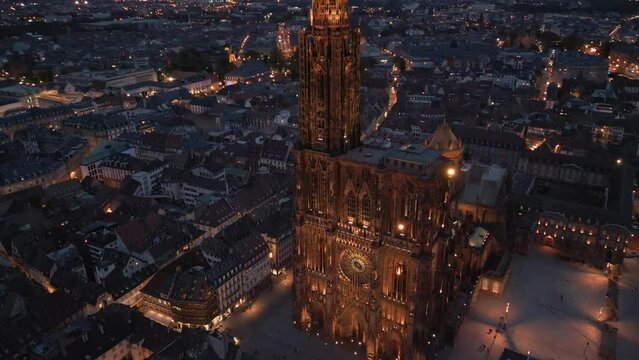 Aerial close up view of Strasbourg Cathedral of Notre Dame illuminated and Petite France old french buildings architecture with beautiful night sky view