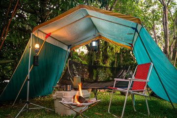 camping in the forest, Folding bed inside the tent, gas lanterns, coffee sets, and outdoor ideas.