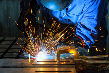 When workers weld using gas argon to steel, sparks are created that result in smoke within factory